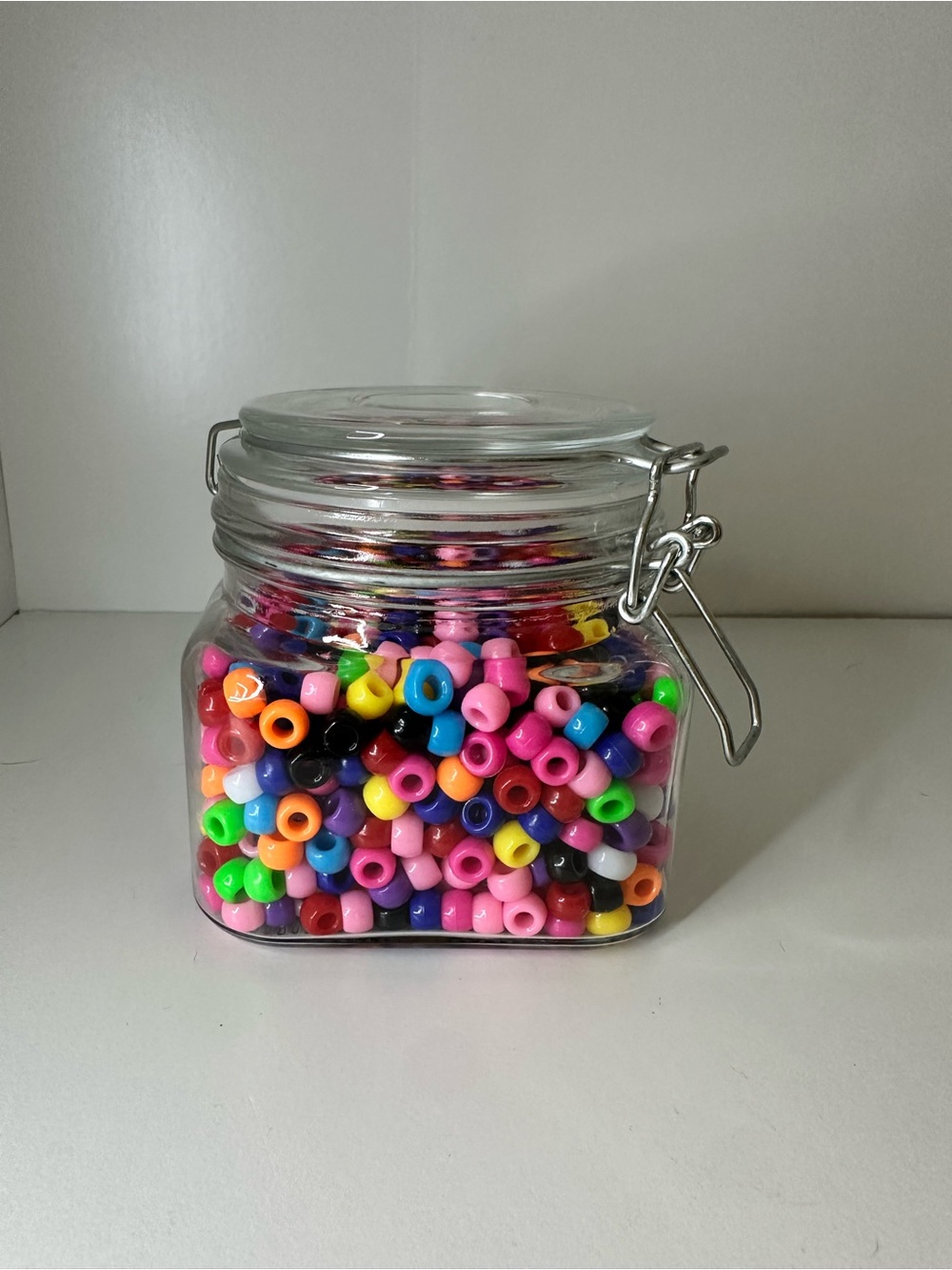 Multi Colored Beads in Clear Glass Airtight Storage Jar with Metal Clamp